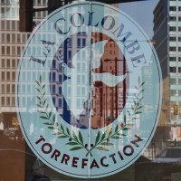 The La Colombe logo with Penn Square in the background