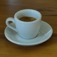 An espresso, made by my Rancilio Silvia espresso machine, in a classic white cup and saucer from Acme & Co., New Zealand, distributed in the UK by Caravan Roastery.