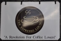 The Espresso Lounge sign, promising "A Revolution For Coffee Lovers"