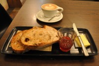 A flat white and two slices of sour dough toast for breakfast at Laynes Espresso. Plus jam in a glass!