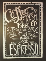 Detail of some of the drawing on the wall behind the bench in Baila Coffee & Vinyl, proclaiming Baila's fresh, brewed coffee and light roast espresso.