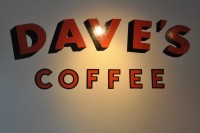 The words "Dave's Coffee" in red on a white wall.