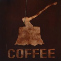 A square with the motif of an axe buried head-first in a tree-trunk above the word COFFEE