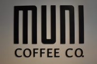 The Muni Coffee Co. logo from the wall behind the counter at the Fulham Road coffee shop.