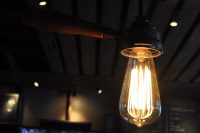 A light bulb from the Cupping Room at Portland Roasting in Portland, Oregon, held in a light-fitting made from an upturned portafilter.