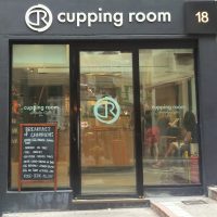 The square facade of The Cupping Room in Central, facing onto the steeply-sloping Cochrane Street.