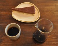 My pour-over, served in a handleless glass carafe with a handleless pottery cup, plus a slice of salted caramel and chocolate shortbread tart, at Nottingham's Cartwheel Cafe &amp; Roastery.