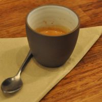 A shot of the guest espresso at Baltzersens in Harrogate, served in a handleless cup.