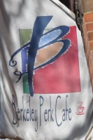 The Berkeley Perk Cafe logo on a flag hanging outside the shop
