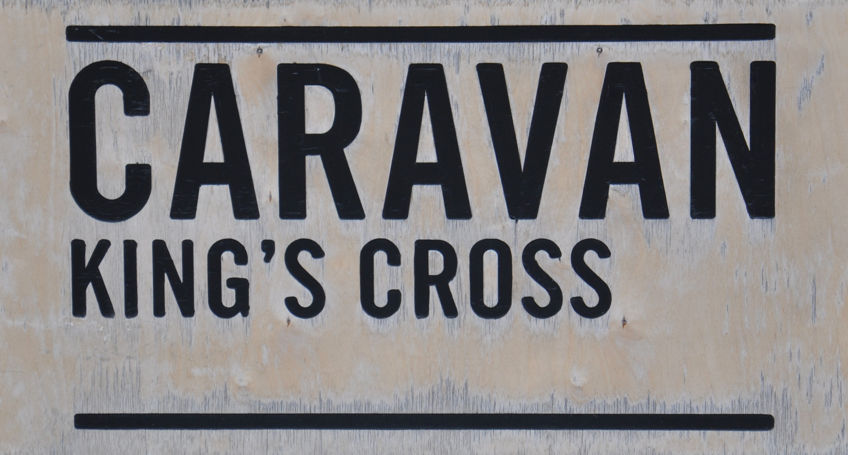 The Caravan King's Cross Sign: "Caravan King's Cross" in black letters on a white background