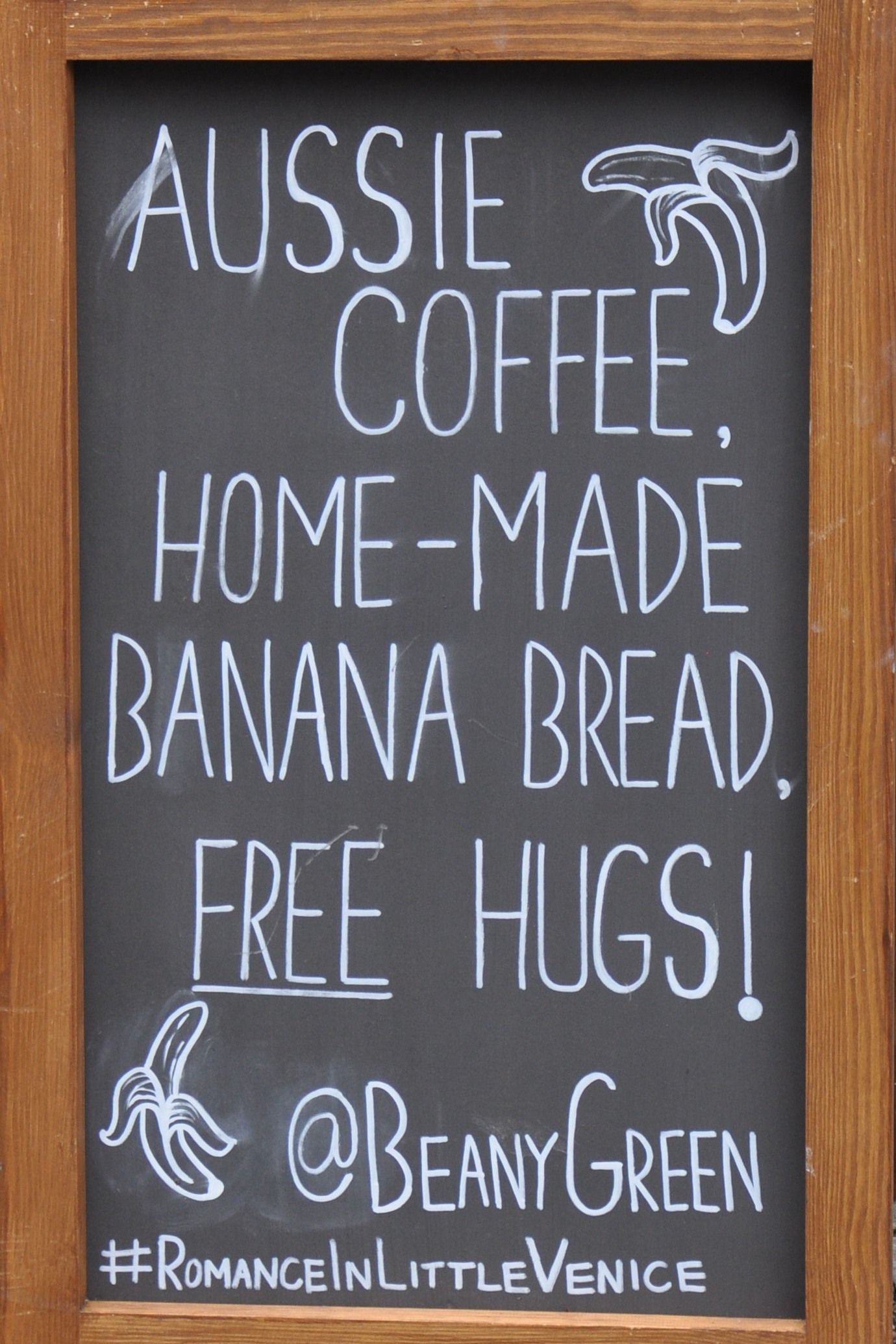 One of Beany Green's A-boards, promising Aussie Coffee, Home-made Banana Bread and FREE hugs!