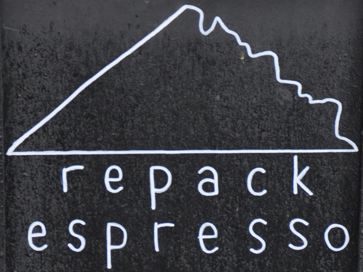 The Repack Espresso logo, a stylised outline of the mountain-biking track it's named after above the words "repack espresso" in lower case.