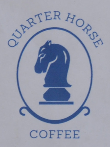 The Quarter Horse Coffee logo: a profile of a knight from a chess set, surrounded by an oval with the words "Quarter Horse Coffee" written around the outside.