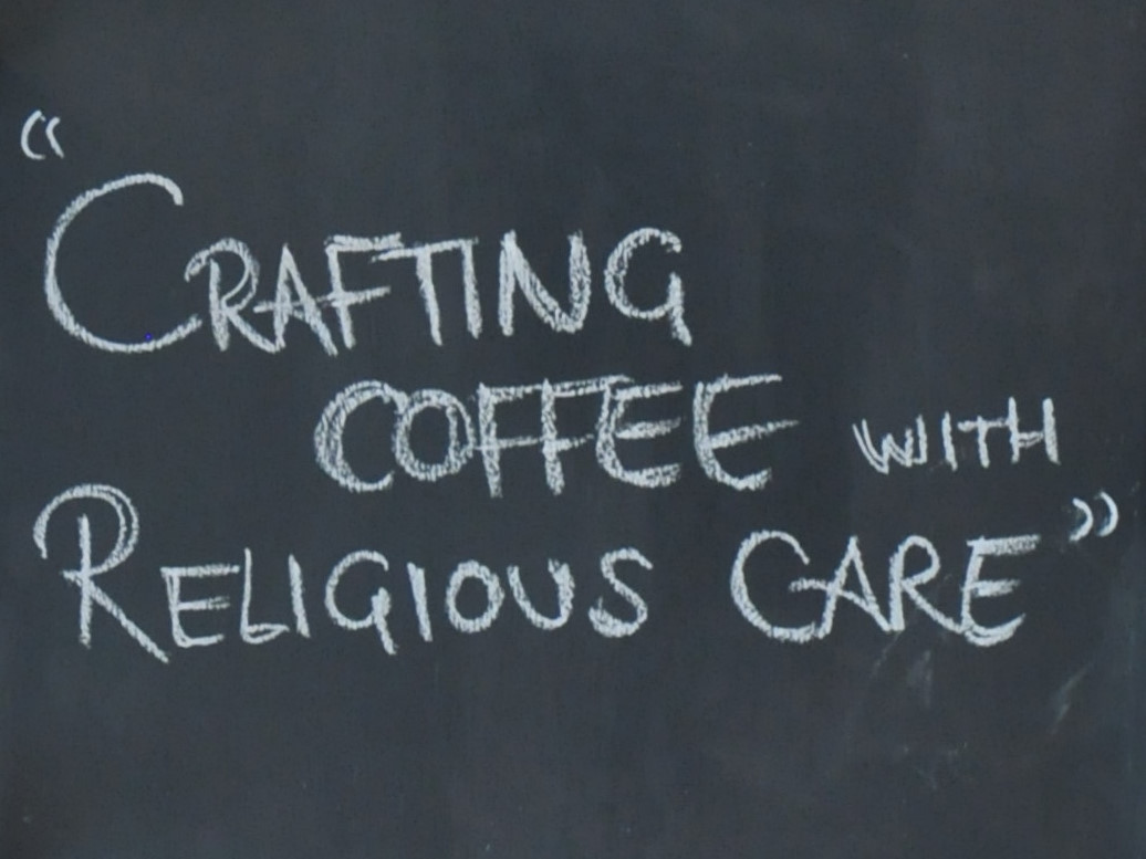 From a black board behind the counter at Saint Espresso: "Crafting Coffee with Religious Care".