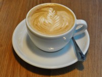 A lovely flat white in a classic white cup, complete with impressive latte-art at Notes at Crossrail Place.