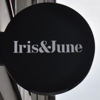 A black circle with the words "Iris&June" written in white inside it