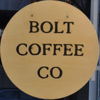 The words "Bolt Coffee Co" written in a circular wooden sign.