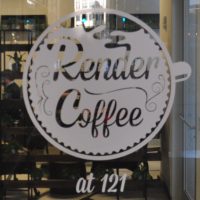 The Render Coffee Logo, a coffee cup seen from above, painted on the window at 121 Devonshire Street in Boston.