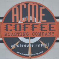 The Acme Coffee Roasting Company logo from the front of its coffee counter in Seaside, CA.