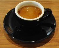 A single-origin Yirgacheffe from And Coffee Roasters, served in a classic black cup by Kaido Books & Coffee
