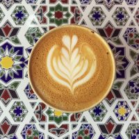 My flat white in my Ecoffee Cup on a lovely patterned tile at Lever & Bloom.