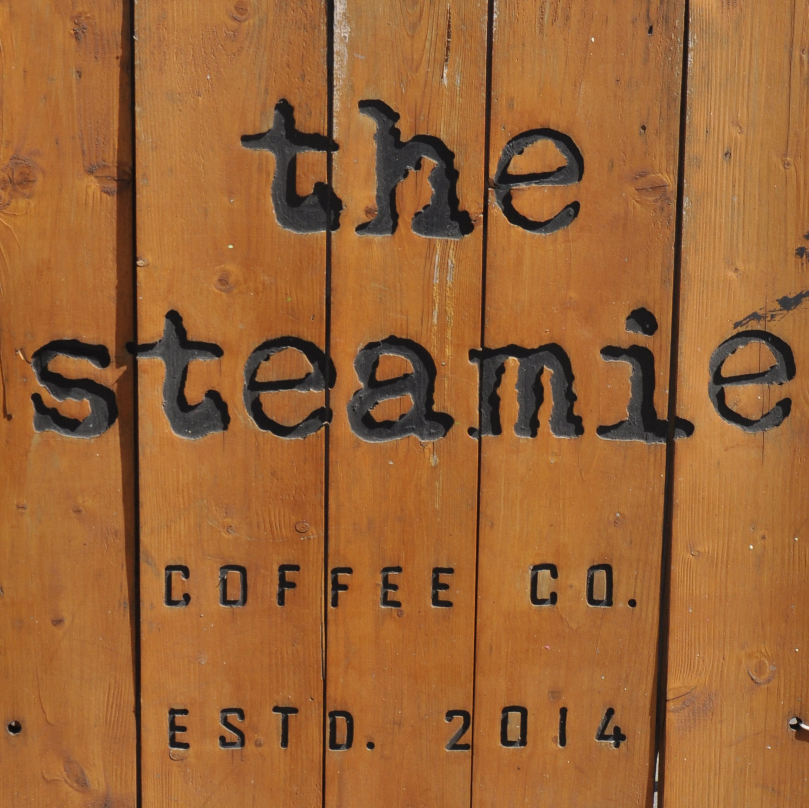 Detail from the A-board outside The Steamie on Glasgow's Argyle Street on a sunny day in May. Reads: "The Steamie Coffee Co. Estd. 2014"