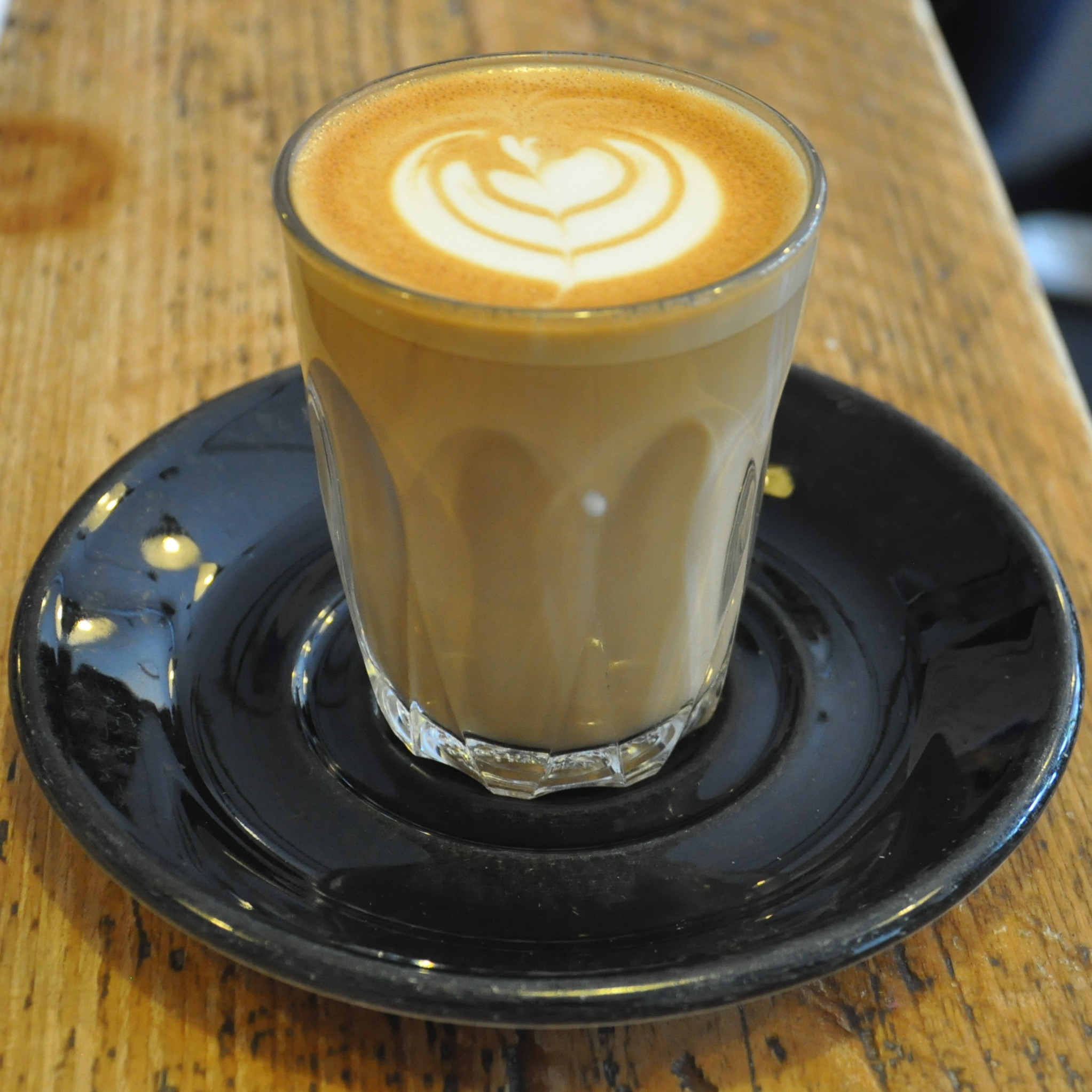 A lovely flat white from Brew Coffee Co, made with a Honduran single-origin, roasted by Clifton Coffee Co, and served in a glass.