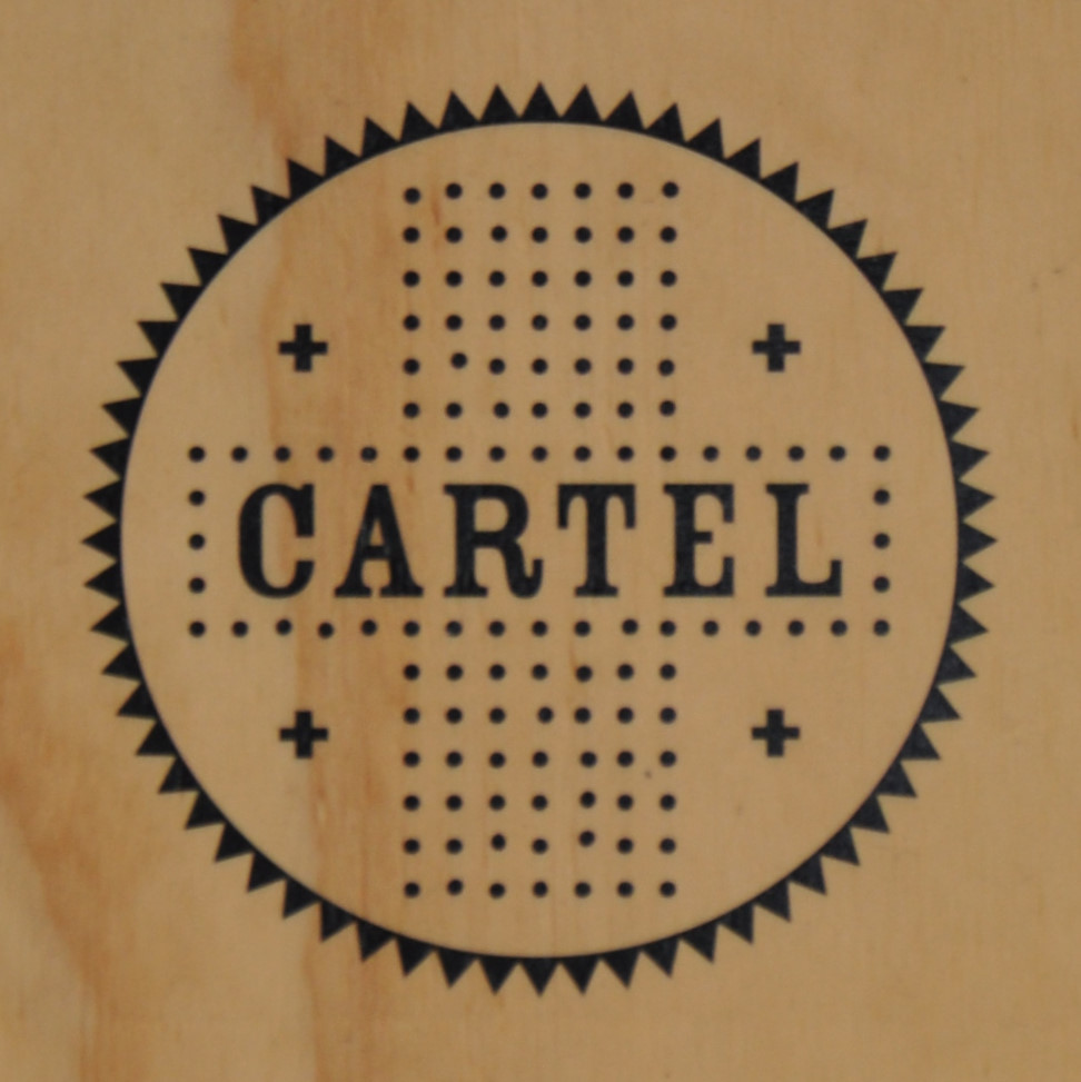 The Cartel Coffee Lab logo from the wooden A-board outside the store in downtown Phoenix.