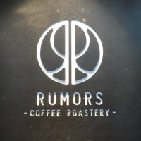 The Rumors Coffee Roastery logo from the front wall of the original Rumors in Shanghai