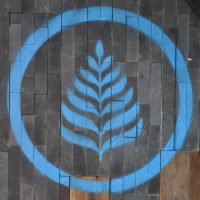 The Lanna Coffee logo, in blue, on the wooden wall of the original Lanna Coffee Shop on Yuyuan Road.