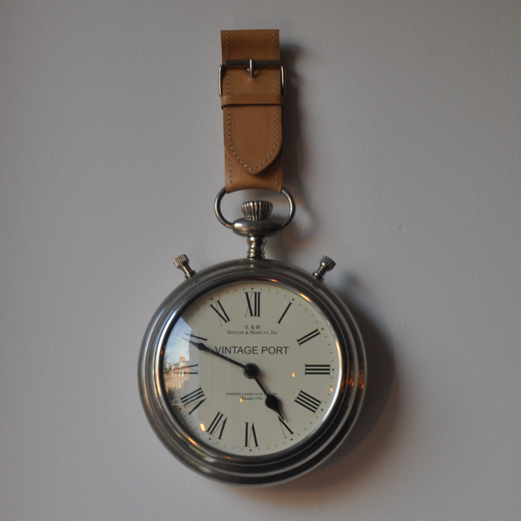 An over-sized pocket-watch, part of the Alice in Wonderland theme, which hangs on the wall by the door at The Pocket in Belfast.