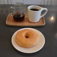 A batch-brew of an El Salvador single-origin, served in a carafe with a mug on the side, plus a lovely, honey-glazed doughnut, at Intelligentsia, Logan Square.