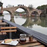 My coffee, overlooking the five stone arches of Fangsheng Bridge in Zhujiajiao from the back terrace of The Point.