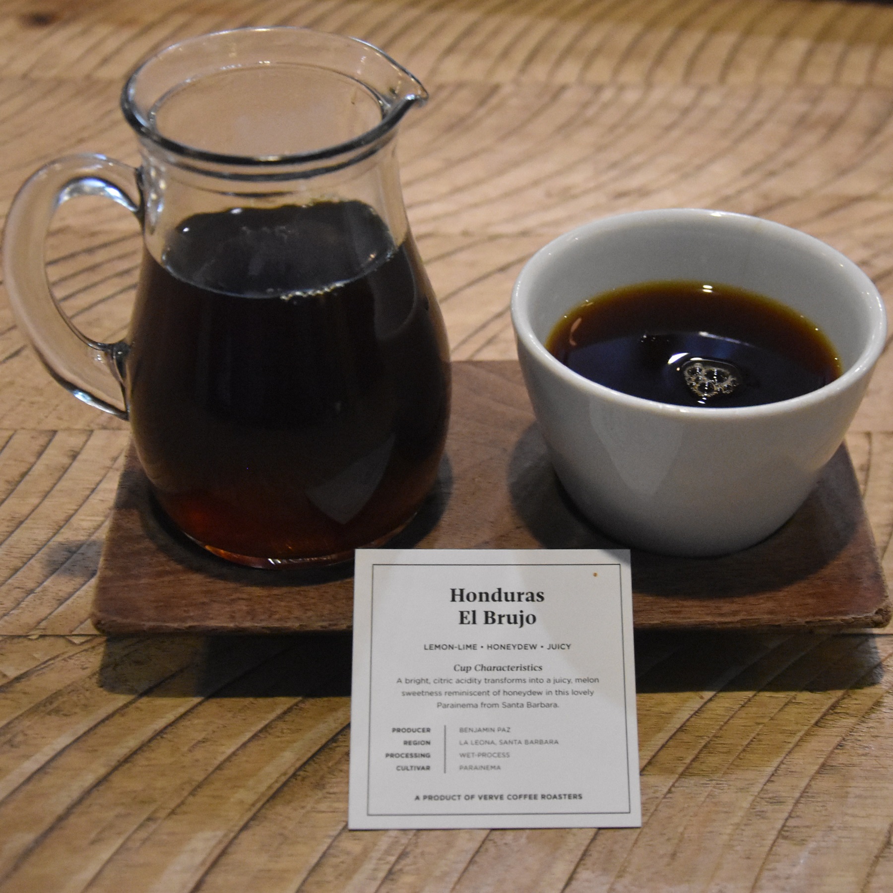 A Honduran single-origin pour-over served at Verve Coffee Roasters on Spring Street, Los Angeles, The coffee comes in a carafe, cup on the side, presented on a wooden tray with a card giving details of the beans.
