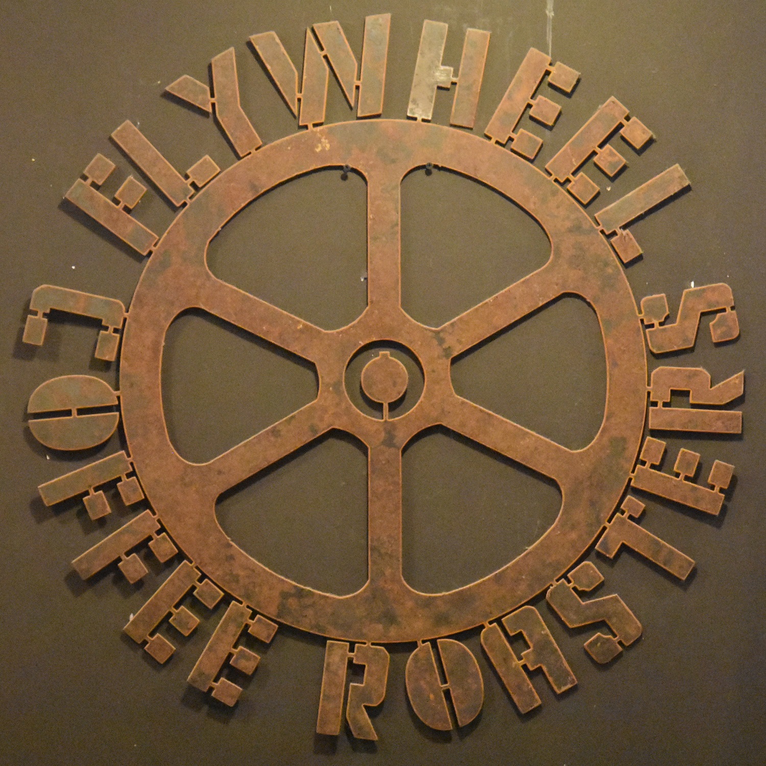 The Flywheel Coffee Roasters logo from the wall of the coffee shop in San Francisco.