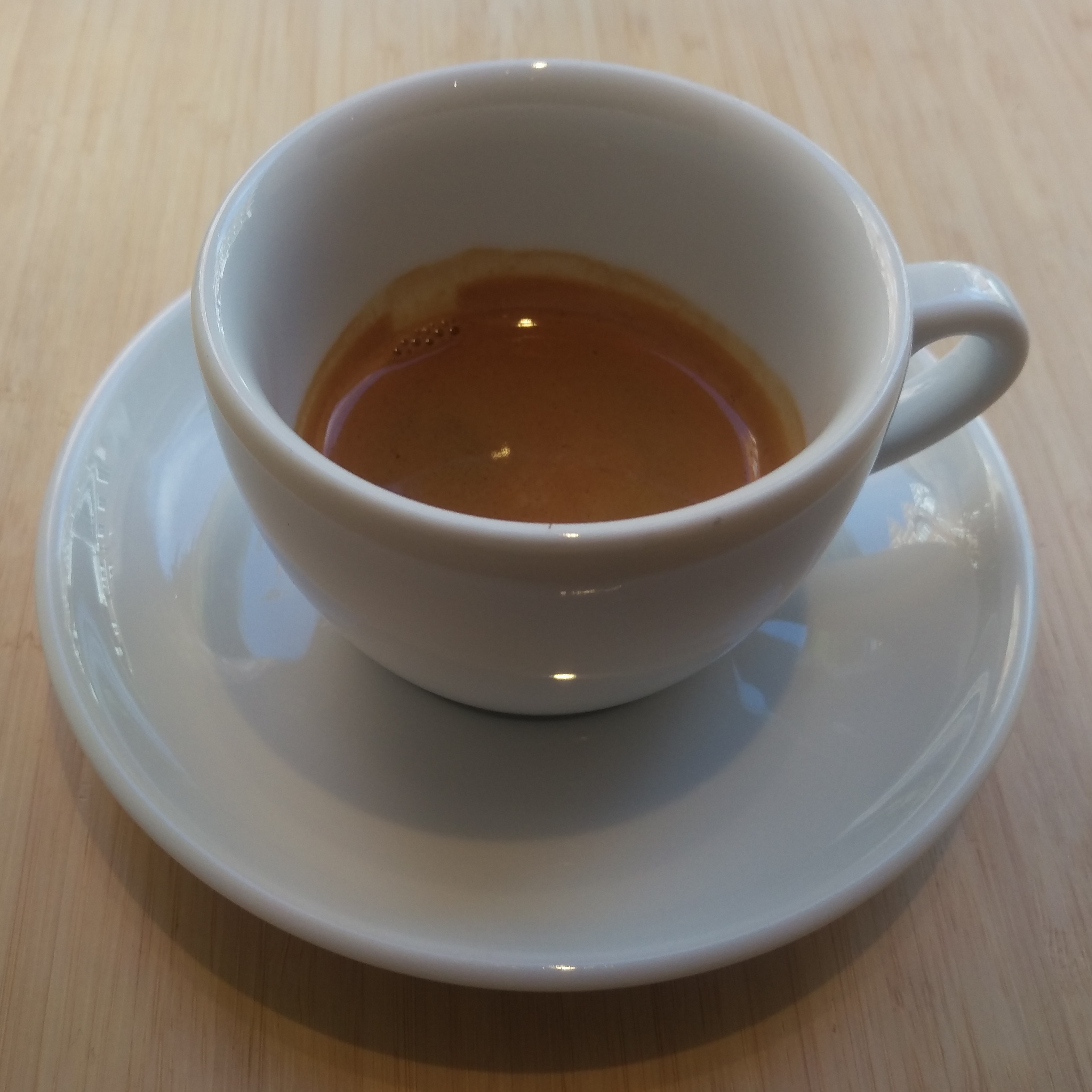 The single-origin Brazilian espresso from Red Bank Coffee served in an over-sized, classic white cup at Alex Coffee.