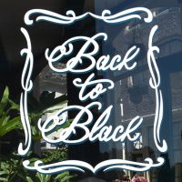 Details from the sign for Back to Black, written in a cursive script in the window of the coffee shop on Weteringstraat.