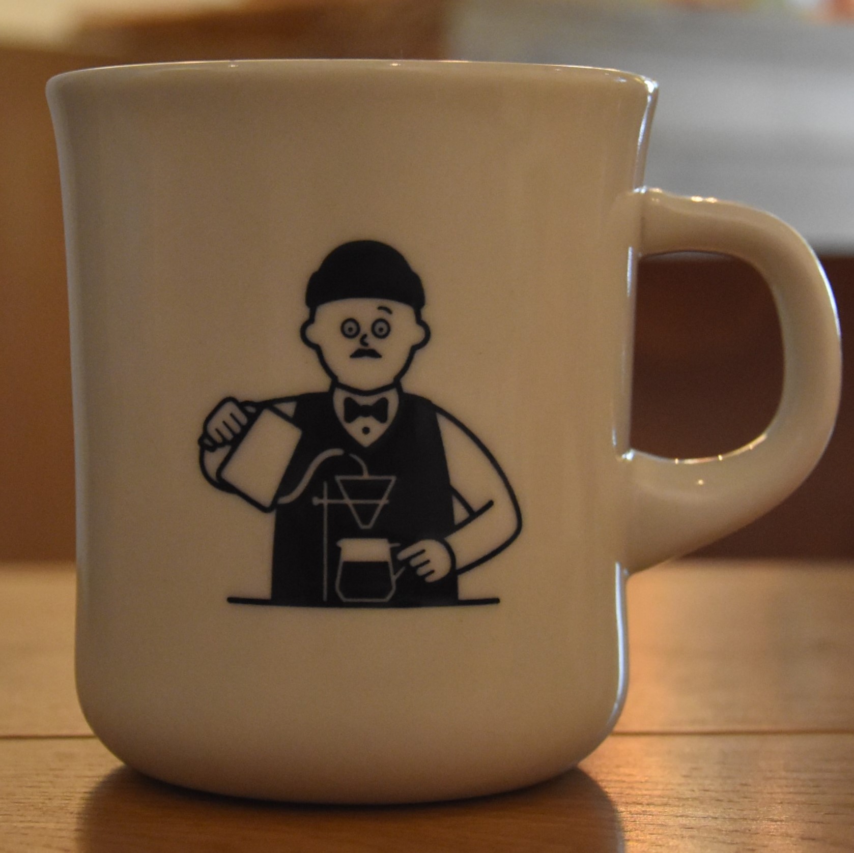 A cartoon figure of a man making a pour-over from the side of my mug at Foret Coffee, Nagano.