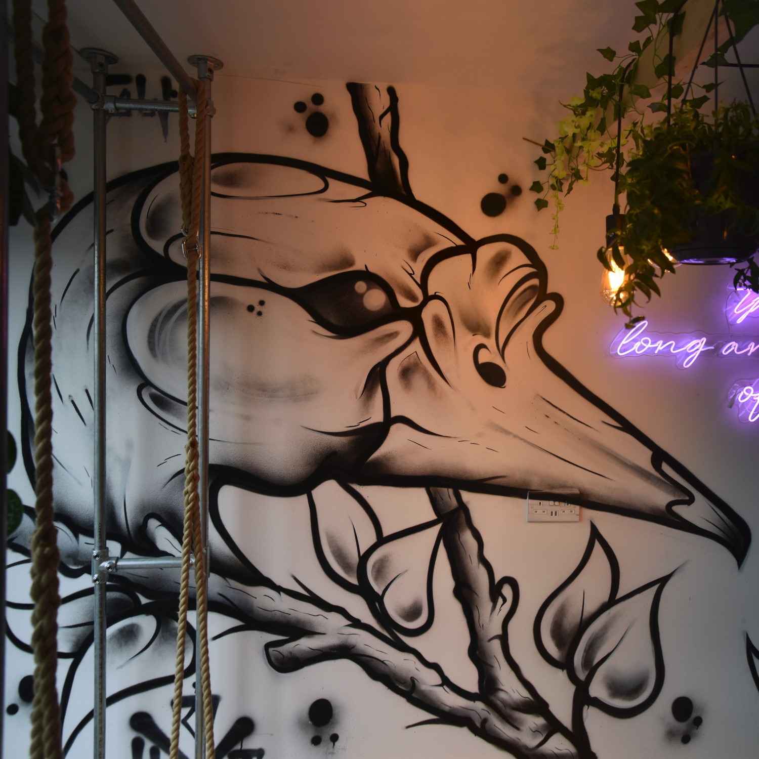 Part of the amazing mural on the wall of Long & Short Coffee in Walthamstow, showing a bird's head.