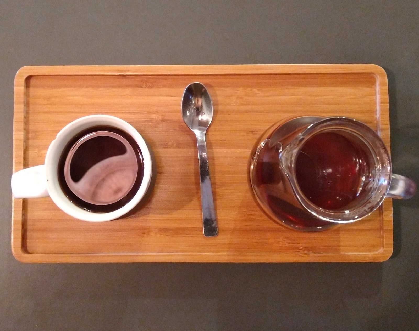 A V60 of a Gakui AA Kenyan single-origin served in a carafe, with the cup on one side, presented on a wooden tray at Coffeeangel TCD.