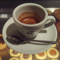 A single espresso in a classic cup at Roscioli Caffè Pasticceria in Rome.