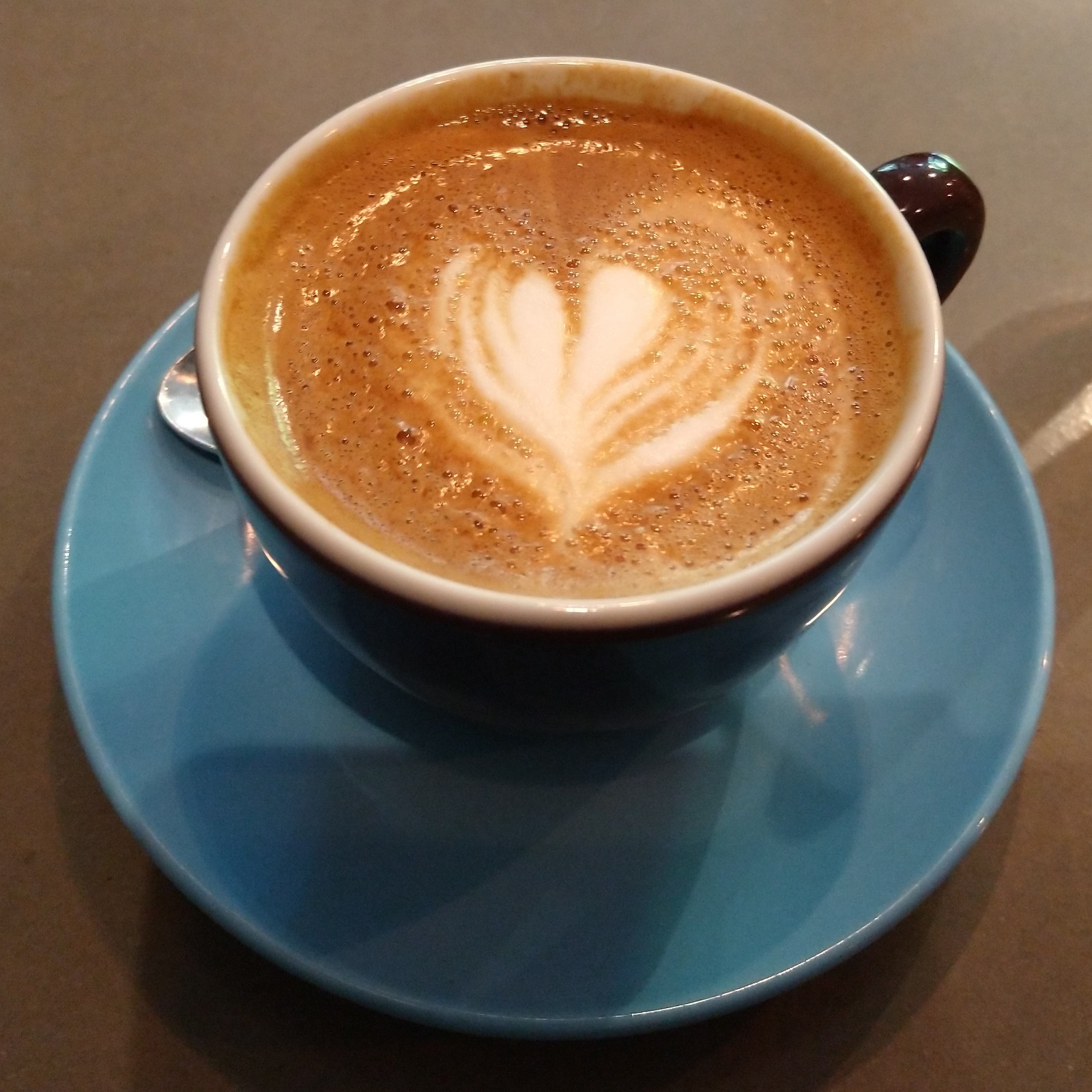 An excellent flat white, made with the Farmhand house-blend, and served in a classic blue cup at Brother Hubbard South.