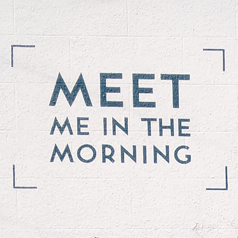 Meet Me in the Morning, written in capitals on the whitewashed upstairs wall next to the window.
