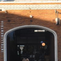 The brick arch leading to the front of the Intelligentsia coffee bar on Abbot Kinney Boulevard in Venice, Los Angeles.