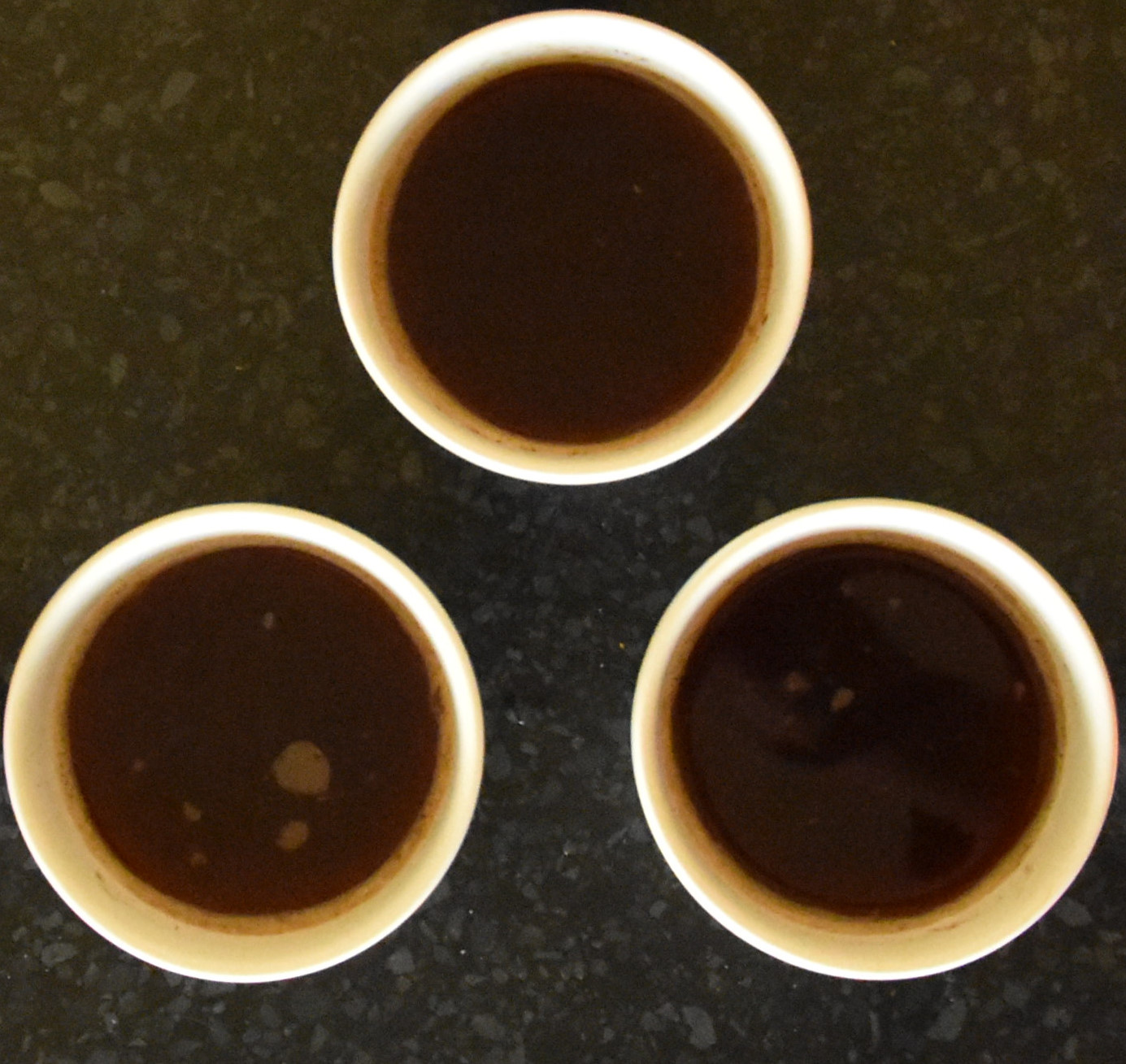 Three bowls of coffee, seen from above, two roasted by Quarter Horse and one by Hundred House. But which is the odd one out?