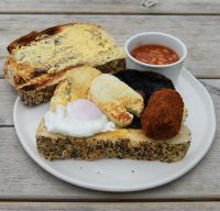 My Vegetarian Stacked breakfast at the Riverbanc in Llangollen: egg, halloumi, mushrooms, croquette, beans and seeded toast (plus an extra slice).