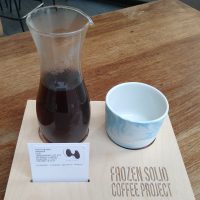 My coffee, the Nano Lot N14, a Gesha grown by Creativa Coffee District in Panama, roasted by The Hub in Malaysia and served in a carafe, with a lovely ceramic cup on the side, all presented on a wooden tray, part of the Frozen Solid Coffee Project at Tilt in Birmingham.