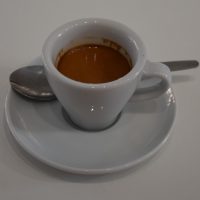 A shot of the Mayni coffee, served as an espresso in a classic white cup at Caffeina Coffi.