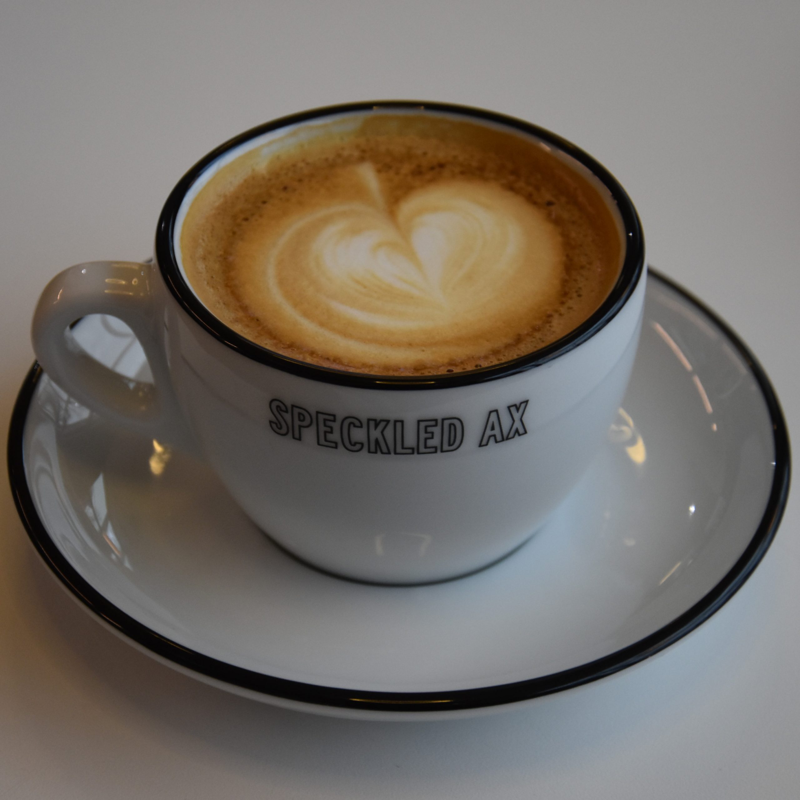 A lovely cappuccino, made with the Honduras El Cedro, a honey processed coffee, served in a classic white cup at Speckled Ax, Thames Street in Portland, Main.