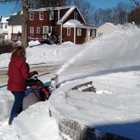 Amanda clearing snow with her snowblower outside her house in Westbrook after a major snowfall in January 2022.
